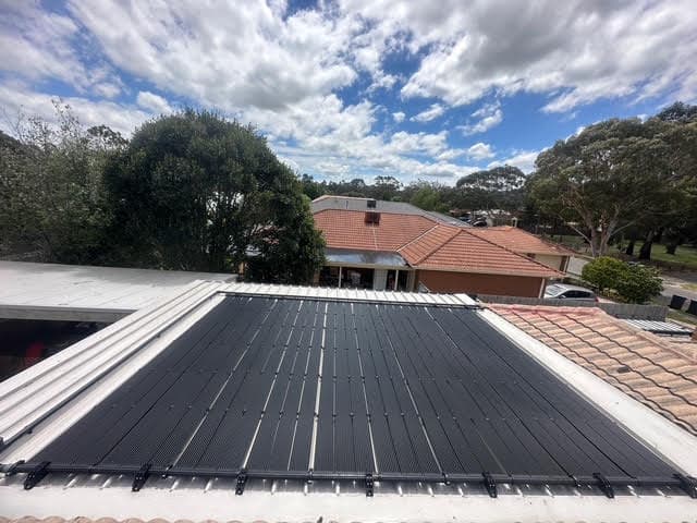Solar pool heating collectors installed on a rooftop